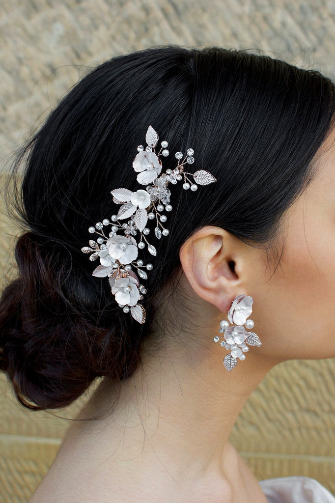 Pale Rose Gold Hair Clip with pearl flowers shown on dark hair
