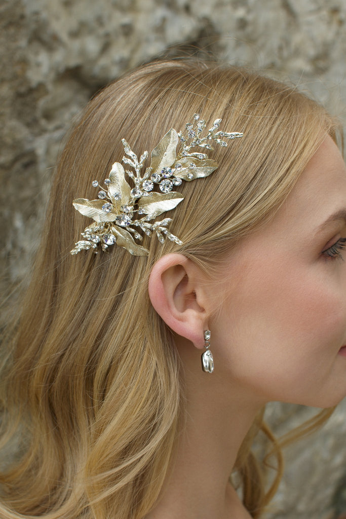 Blonde model wearing pale gold bridal side comb with pear shape gold earring