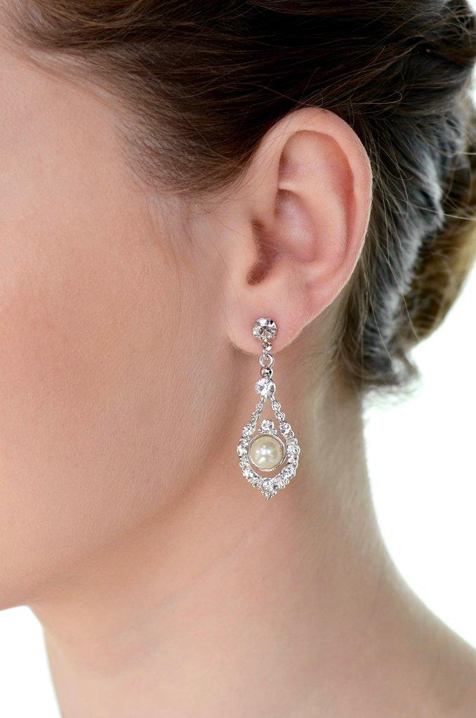 A models' ear wears a pearl drop earring against a white background