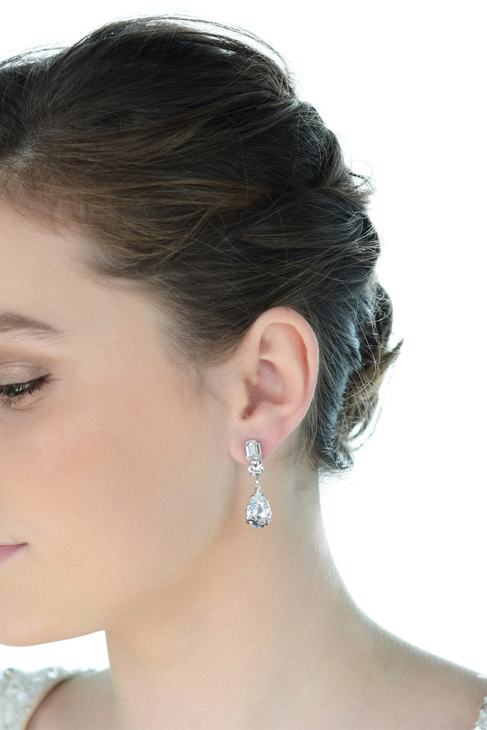 Short Crystal handmade earring worn by a dark hair bride with a white background