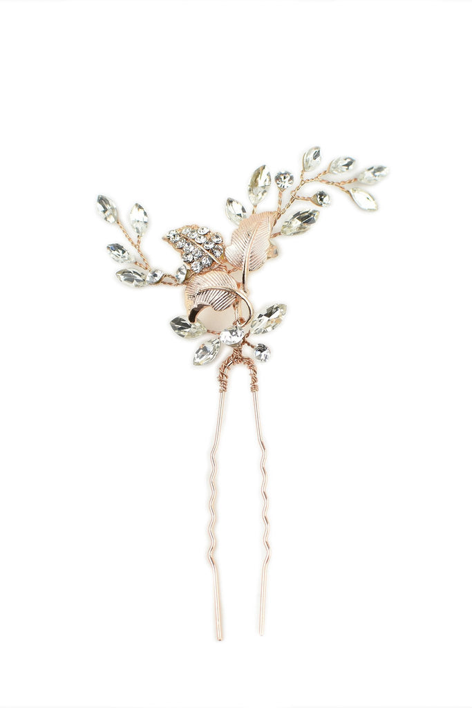 A pale Rose Gold Hairpin with lots of tiny crystals is pictured on a white background