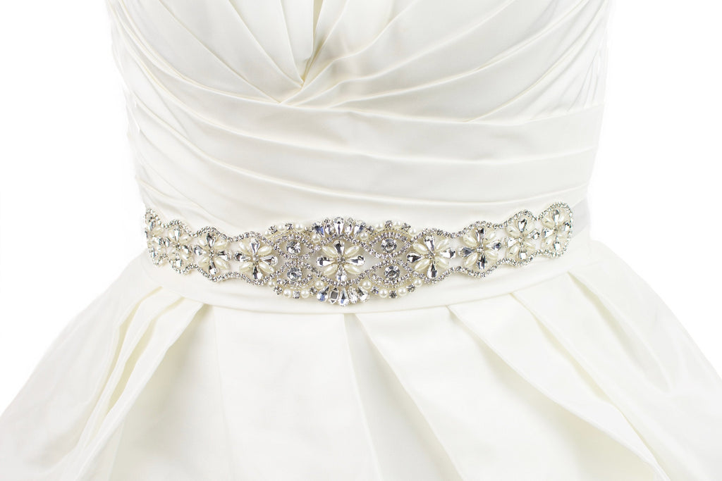 belt on a bridal dress with crystals and pearls on an ivory ribbon on an ivory bridal gown
