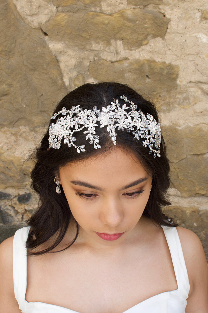 Silver and crystal headband worn by a bridal model at the front of her head