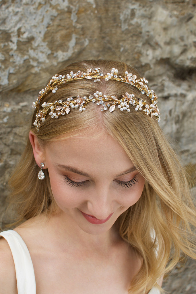 Smiling Blonde Bride wears a headband in gold with a stone wall backdrop