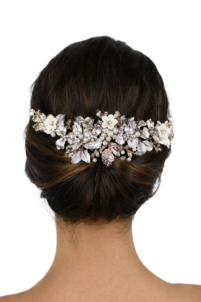Pale Rose Gold Bridal Headpiece with ceramic flowers worn at the back of a models head with a white background