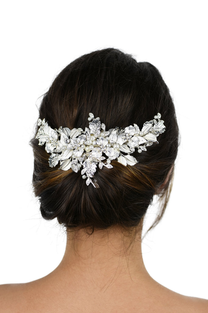 Silver leaves wide headpiece with pearls worn on the back of a dark hair model with a white background