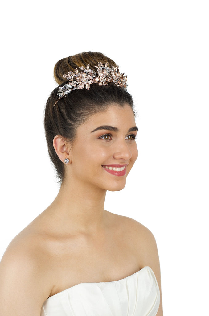 Rose Gold Crown worm by a smiling bride in an ivory bridal gown with a white background