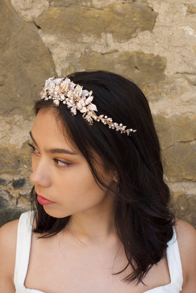 Black haired model wears a pale rose gold and pearl low bridal headband