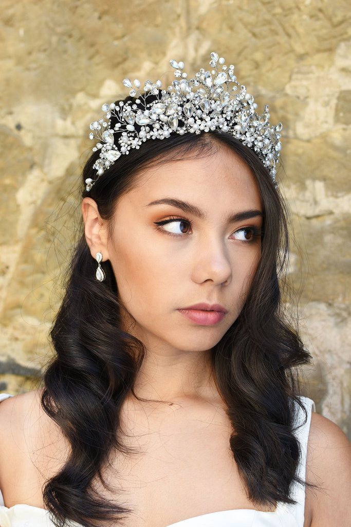 A Bride wears a high Tiara of pearls and Swarovski Crystals on her dark hair 